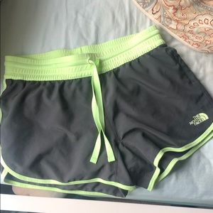 Dark grey north face shorts with neon green lining